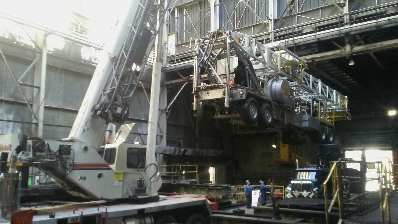 crane lifting large truck