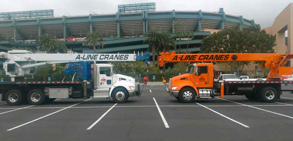 two cranes parked in front of the angel stadium in anaheim california